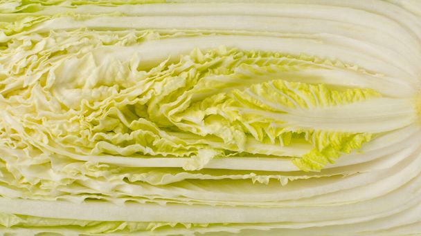 Half of Chopped Chinese Cabbage, Napa Cabbage or Wombok Texture Background. Fresh Green Sliced Cabbage Salat Pattern - Valokuva, kuva