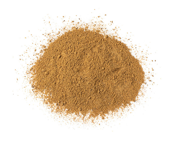 Pile of garam masala powder mix isolated. Ground spice mixes and blended herbs with fennel powder, ground peppercorns, cloves, cinnamon, mace, cardamom, curry, cumin, coriander top view - Photo, Image