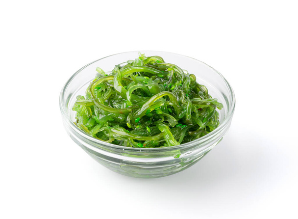 Grüner Chuka Algensalat isoliert auf weißem Hintergrund. Wakame-Seetang-Salat, Tschukka-Seegras, gesunde Algennahrung - Foto, Bild
