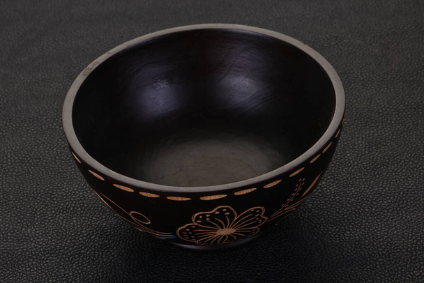 Empty wooden bowl over black background - Photo, Image