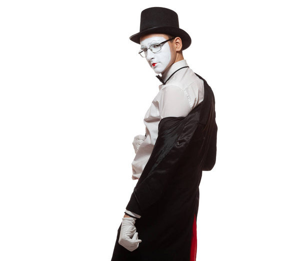 Portrait of a male mime artist performing, isolated on white background. Takes off his jacket. Symbol of seduction, charm, flirting, fascination - Photo, image