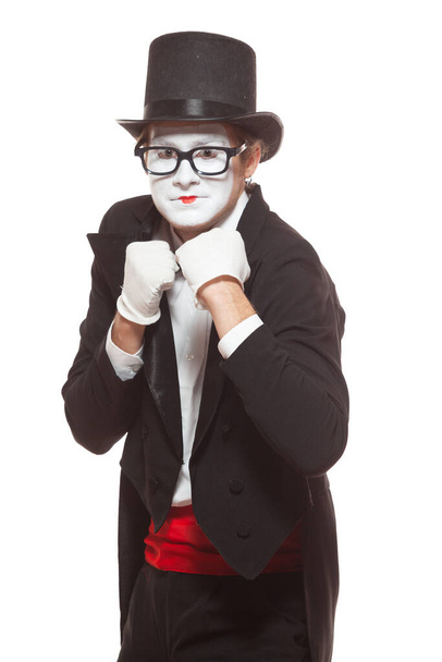 Portrait of male mime artist performing, isolated on white background. Mime in a stand ready to box. Symbol of fight, win, compete - Zdjęcie, obraz