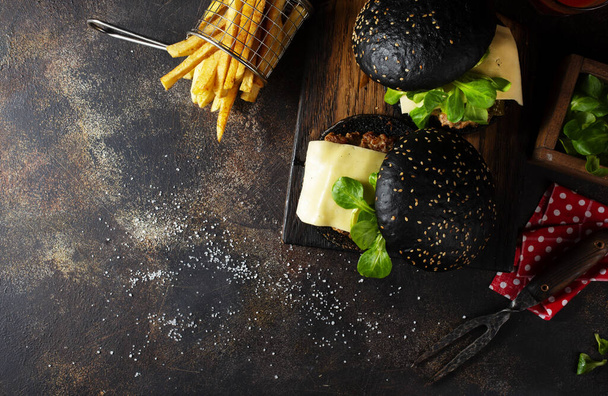 black burger with potato free on wooden board - Photo, image