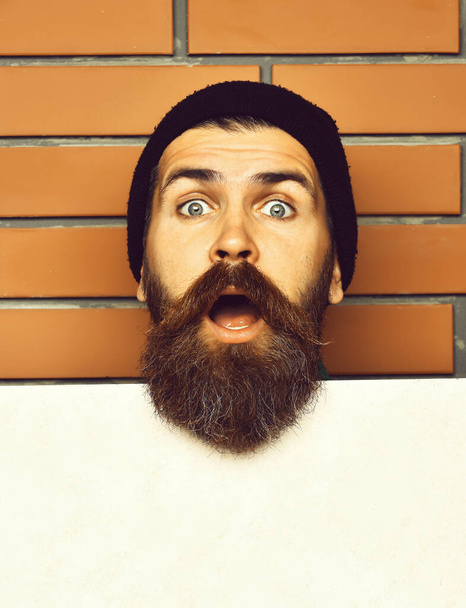 Bearded brutal caucasian hipster with white paper sheet - Φωτογραφία, εικόνα