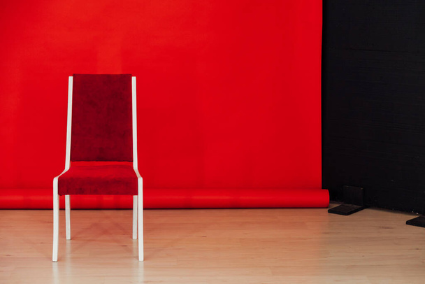 one chair in the interior of the room with a red background - Фото, изображение