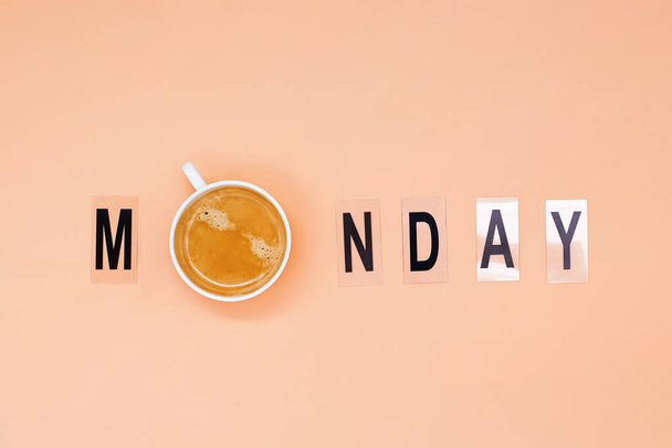 Cup of coffee as letter O in word Monday arranged from print letters. - Zdjęcie, obraz
