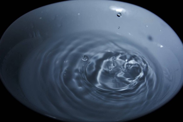 Drop of water on white bowl, cold tones, bluish, waves, - Photo, Image