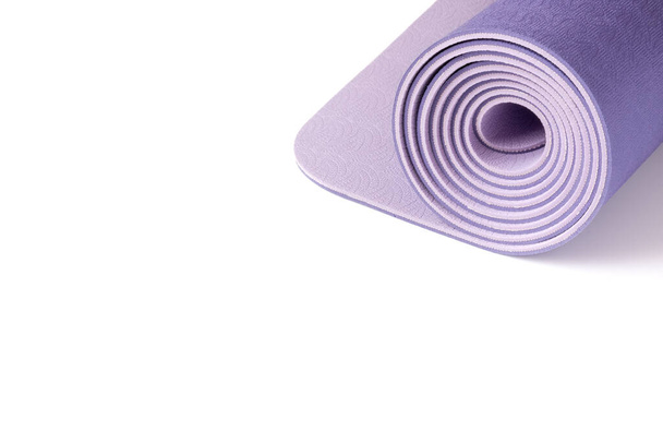 Yoga mat on a white background. Copy space - 写真・画像