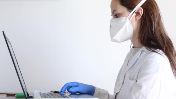 nurse with protective mask in medical office - Materiał filmowy, wideo