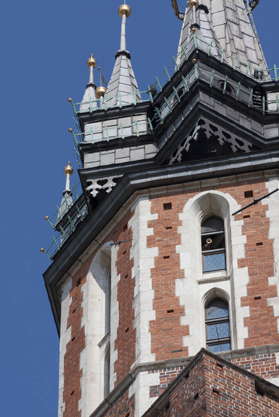 St. Mary's Basilica (Church of Our Lady Assumed into Heaven) in Krakow / Cracow, Poland. Trumpeter, bugler playing an hourly bugle call in a window. Cracow symbols - Photo, Image
