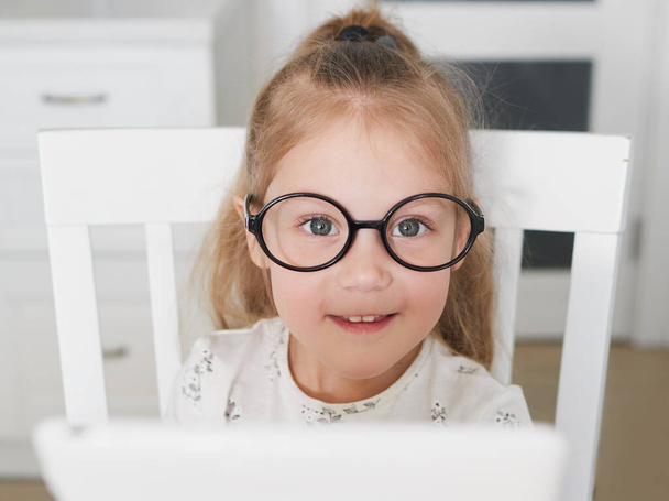 Online Education concept. Little child girl using laptop for distance learning at home - Valokuva, kuva