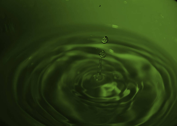 Drop of water on white bowl, green tones, bluish, waves, - Photo, Image