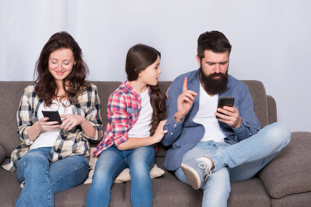 Offended feelings. Stop ignoring kid. Stuck in online. Ignored child. Busy parents surfing internet smartphones. Dad and mom ignoring daughter needs. Bad habits. Parenthood failure. Ignored baby - 写真・画像