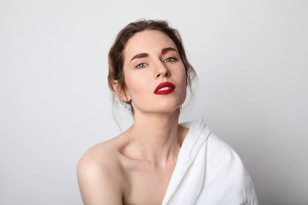 Beauty side portrait of young woman with red lips. Close-up portrait. - Fotó, kép