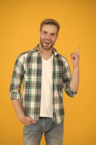 great idea. inspired student yellow background. Make You Look Good. casual fashion for men. Masculine Outfits And Look. stylish male in fashionable clothing. handsome man in checkered shirt and jeans - Foto, Imagen