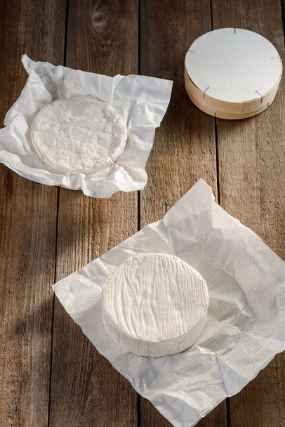 French Camembert soft cheese on wooden background - 写真・画像