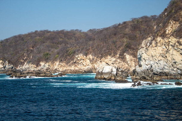 Blue ocean in huatulco bay and rock formations - 写真・画像