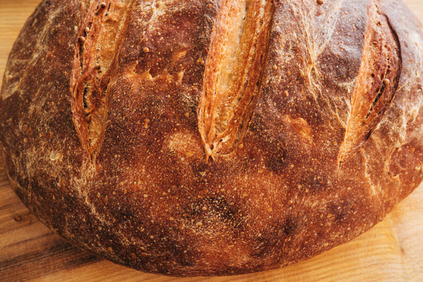 Round rye homemade bread close-up. Fresh, food, bakery, baking, cooking - Photo, Image