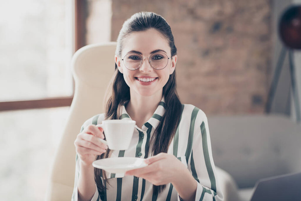 Portrait of positive cheerful lawyer girl rest relax on work hold cup with espresso coffee enjoy break wear spectacles in modern workstation - Fotografie, Obrázek