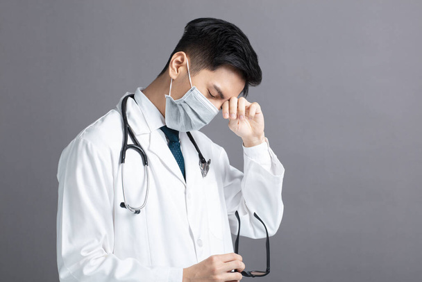 stress and tired young Doctor Wear Medical Mask - Foto, Bild