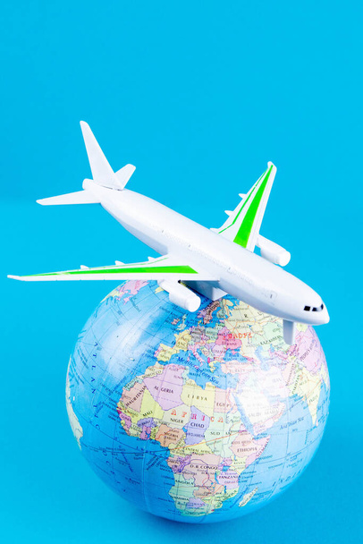 Plastic toy plane on the globe. Flight travel concept. Travel by airplane. Takeoff and landing of the aircraft. Return home from flight. empty Copy space. - Φωτογραφία, εικόνα