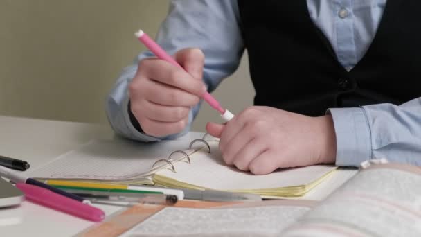 Teenage girl in a school uniform does homework - Felvétel, videó