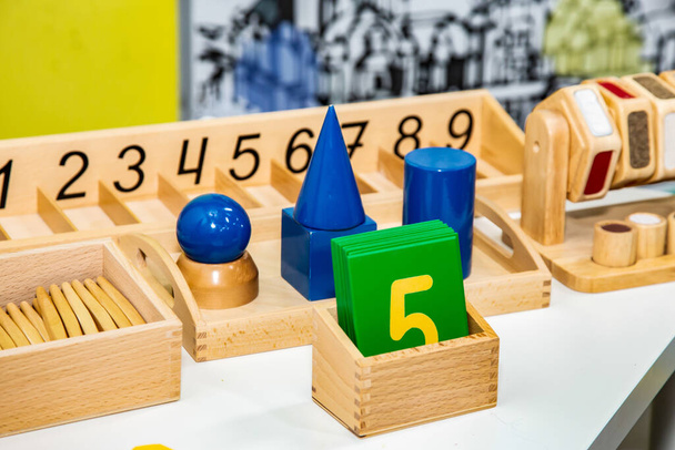 Educational wooden toys. Circle, pyramid, triangle, rectangle wooden elements of children's toys. Multi-colored toy blue, yellow, red, green. - 写真・画像