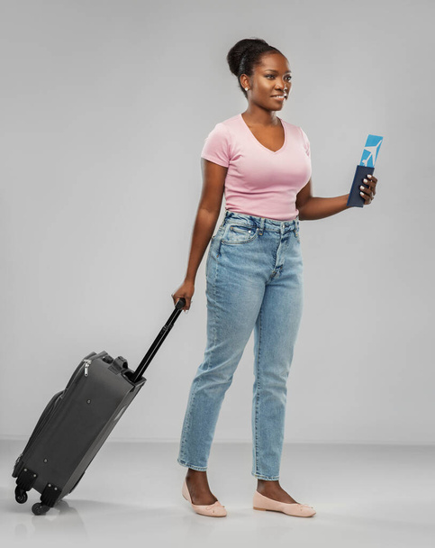 happy young woman with air ticket and travel bag - Fotó, kép
