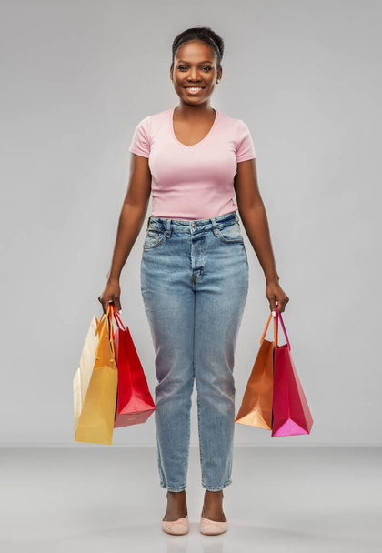 happy african american woman with shopping bags - Фото, зображення