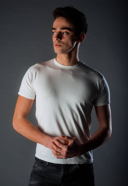 Studio body shot of a trendy young man wearing modern style clothes - Foto, Bild