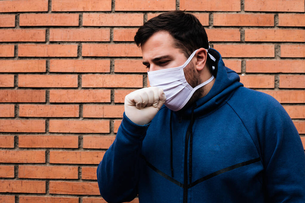 Man is coughing with a medical mask - Valokuva, kuva