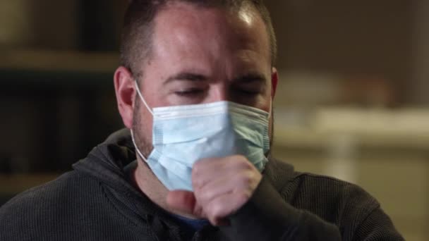 Man wearing face mask starting to cough a lot as one of the symptoms of coronavirus. - Materiał filmowy, wideo