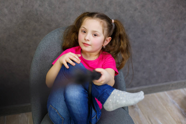 Egy pólós lány csinál egy szelfit a telefonjával és pózol. - Fotó, kép