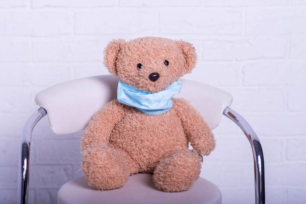 Teddy bear wears a protective medical mask, closeup. Coronavirus. Protection during a pandemic. - Photo, image