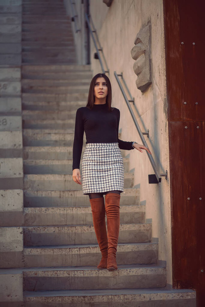 Girl model goes down the steps of the building outside - Foto, immagini