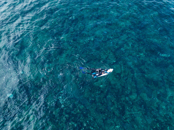 surfing instructor instructs you to ride the waves in the ocean top view shot from the air - Photo, Image