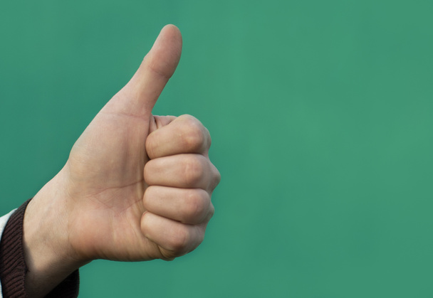male thumbs up on green background  - Photo, Image