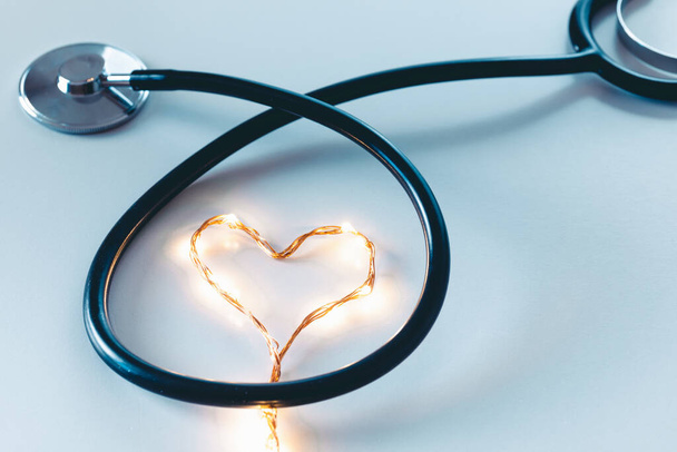 Stethoskop mit Herzzeichen Girlande auf blauem Hintergrund - Foto, Bild