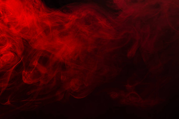 Red steam on a black background. Copy space. - Foto, afbeelding