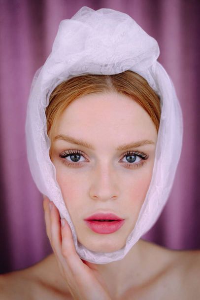 portrait of a girl on a pink background. Young woman with a white scarf - Fotoğraf, Görsel