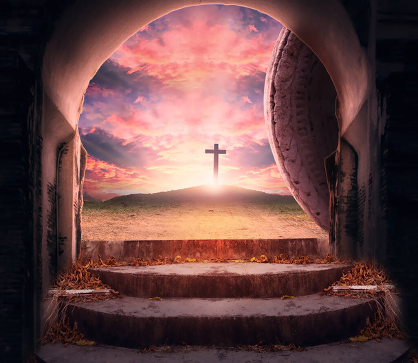 Easter Sunday concept: Tomb empty with cross on sunset background - Photo, Image