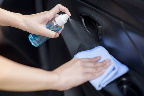 Close up of woman  hand is cleaning  car by alcohol spray  - 写真・画像