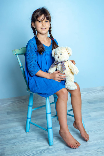 indoor portrait of young child girl with teddy bear, isoalted studio shot - Photo, Image