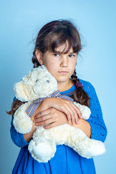 indoor portrait of young child girl with teddy bear, isoalted studio shot - Photo, Image