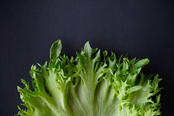 Lettuce on a dark background, healthy eating concept - Фото, изображение