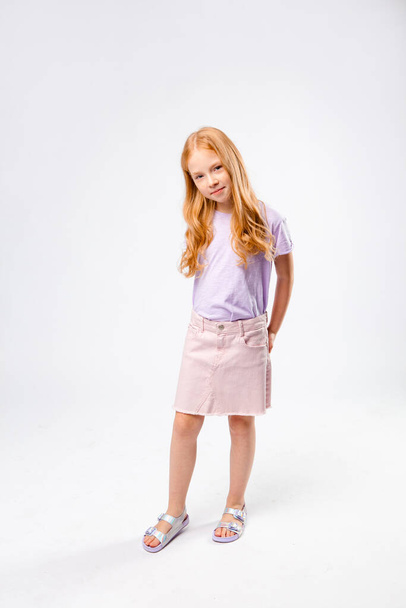 red-haired girl stands with her hands in her pockets - Photo, Image
