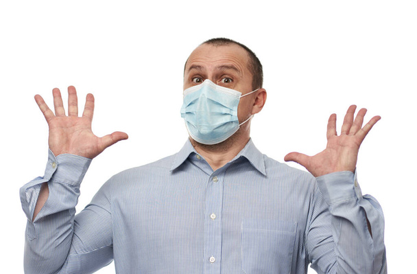Man wearing protective surgical mask against coronavirus, isolated on white background - 写真・画像