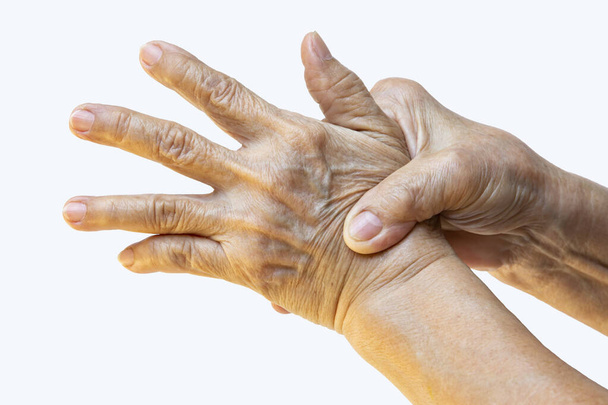 Trigger Finger, La mano derecha de la mujer mayor masajeando su mano izquierda Sufriendo de dolor en el fondo blanco, Primer plano & Macro shot, Síndrome de oficina, Atención médica, Masaje, Concepto de cuerpo asiático
 - Foto, imagen
