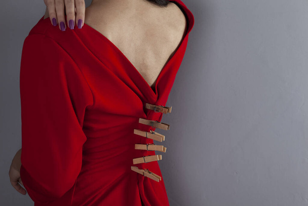 woman dress  clothespins on the grey background - Φωτογραφία, εικόνα