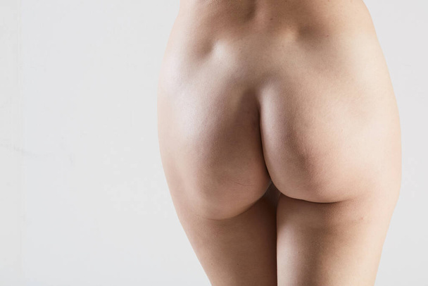 Beautiful buttocks of a nude woman. Close up. No retouch. - Zdjęcie, obraz